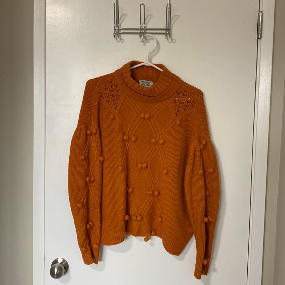 Ernest & Kelly orange turtleneck sweater with fun pom poms
